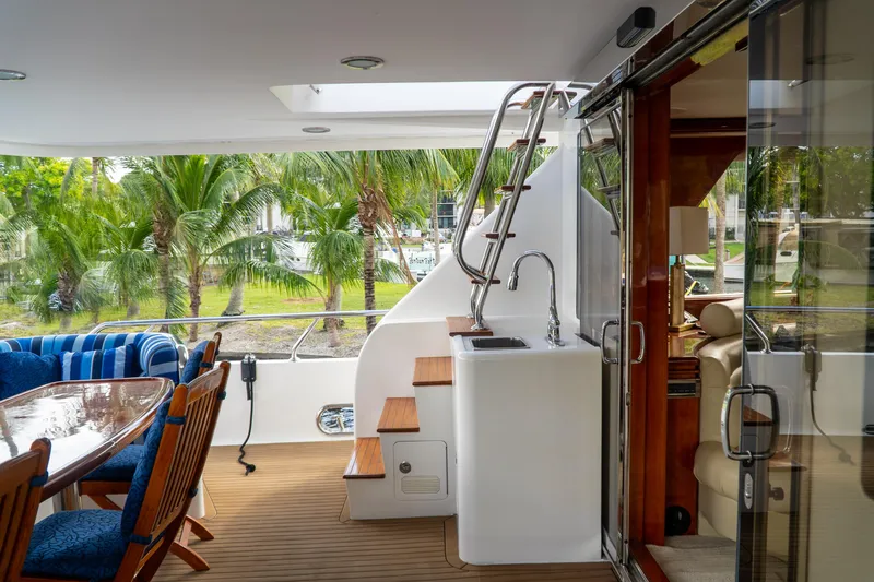 Jusmad Yacht Photos Pics Luxurious 2005 Ocean Alexander 80 yacht deck with seating and outdoor sink.