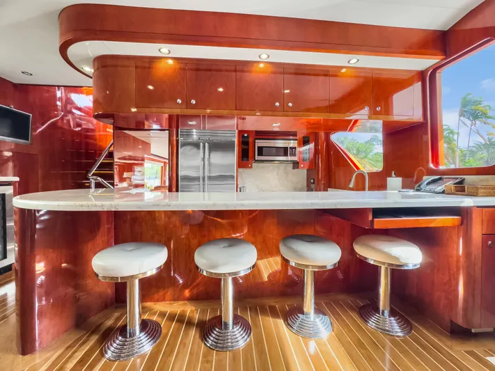 Jusmad Yacht Photos Pics Luxurious kitchen interior of 2005 Ocean Alexander 80 yacht with sleek bar stools and modern appliances.