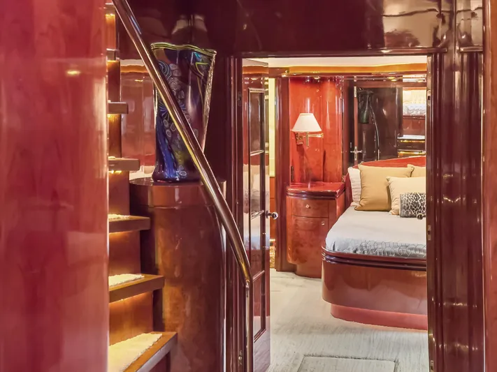 Jusmad Yacht Photos Pics Luxurious interior of 2005 Ocean Alexander 80 yacht with elegant wood finishes and cozy bedroom.