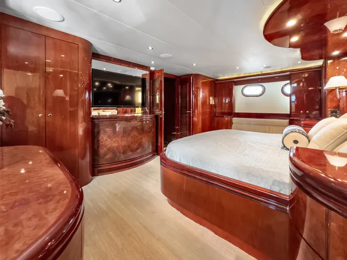 Jusmad Yacht Photos Pics Luxurious bedroom interior of 2005 Ocean Alexander 80 yacht with elegant wood finishes.