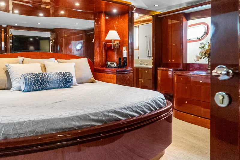Jusmad Yacht Photos Pics Luxurious bedroom interior of 2005 Ocean Alexander 80 yacht with elegant wood finishes.