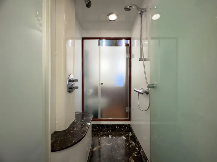 Jusmad Yacht Photos Pics Luxurious bathroom in 2005 Ocean Alexander 80 yacht with marble accents and modern shower.