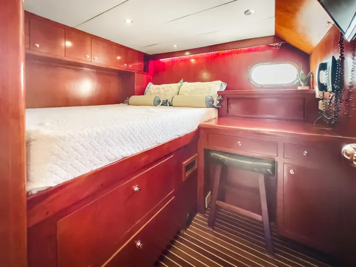 Jusmad Yacht Photos Pics Luxurious cabin interior of 2005 Ocean Alexander 80 yacht with wood finish and cozy bed.
