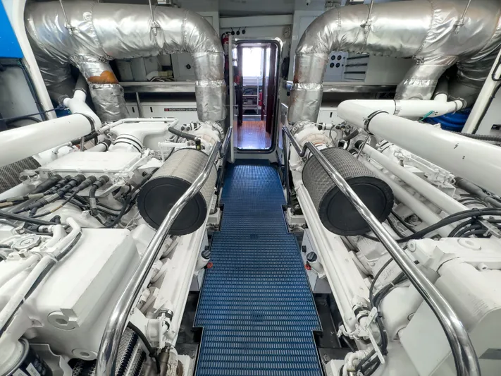Jusmad Yacht Photos Pics Engine room of 2005 Ocean Alexander 80 yacht, featuring dual engines and metallic piping.