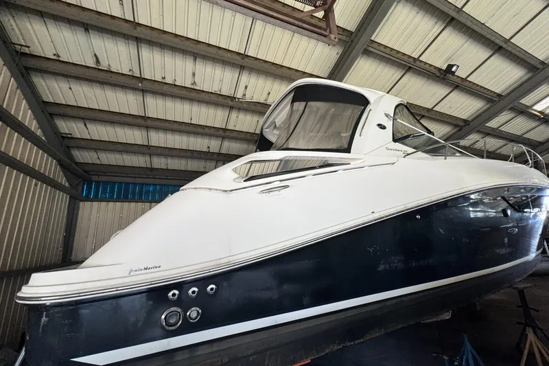  Yacht Photos Pics 2013 Sea Ray 370 Sundancer yacht in a storage facility, showcasing sleek design and structure.