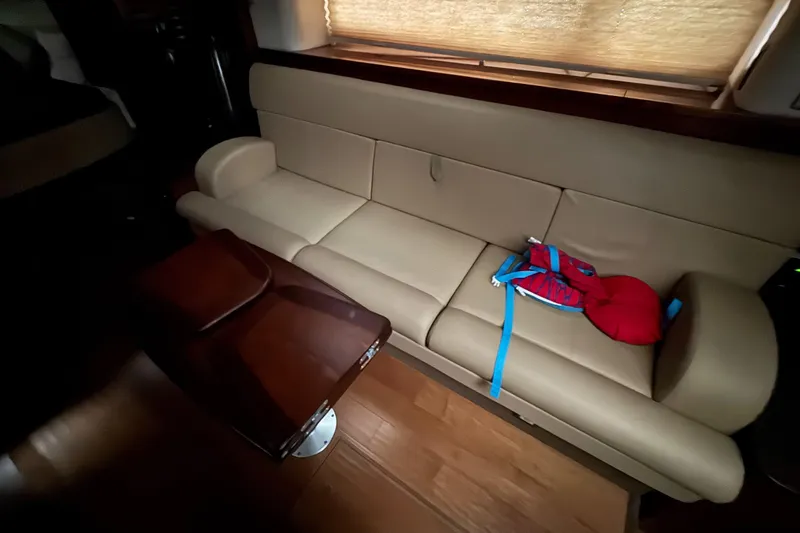  Yacht Photos Pics Interior of 2013 Sea Ray 370 Sundancer with beige sofa and wooden table.