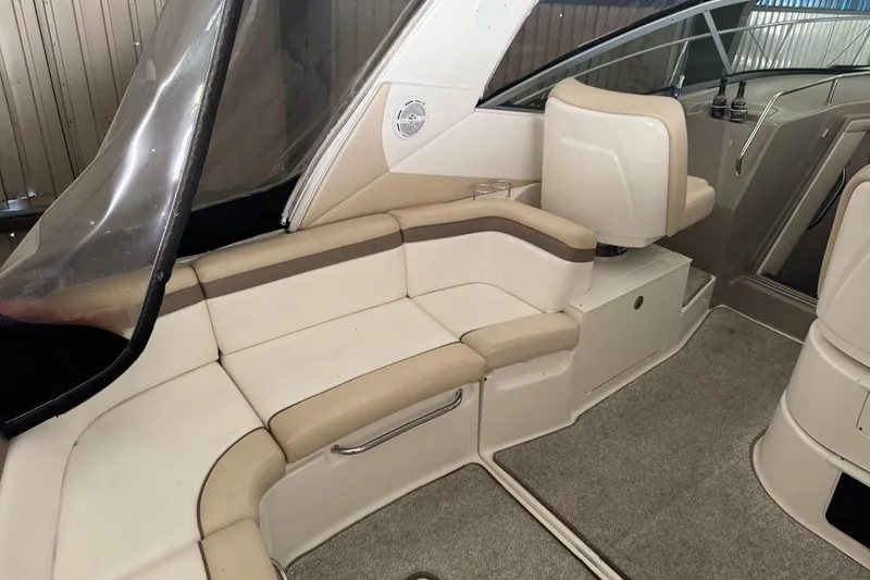  Yacht Photos Pics Interior of a 2013 Sea Ray 370 Sundancer boat with beige seating and carpeted floor.