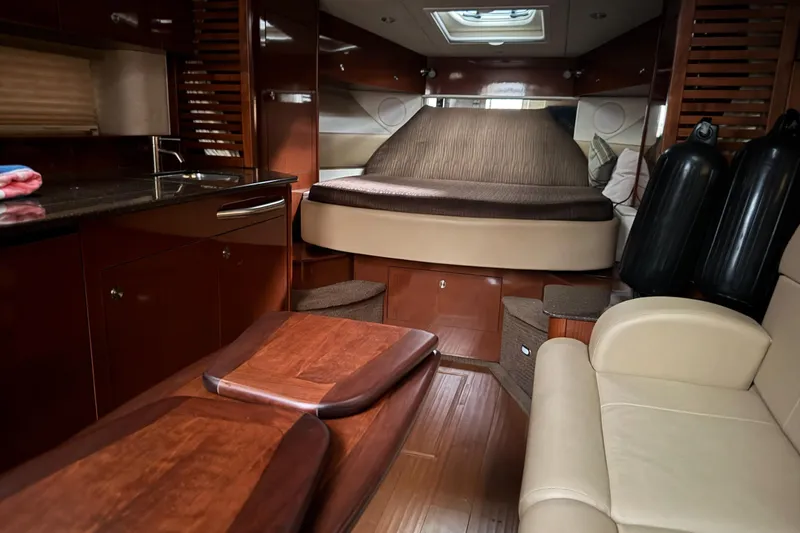  Yacht Photos Pics Luxurious interior of 2013 Sea Ray 370 Sundancer yacht with cozy seating and elegant wood finishes.