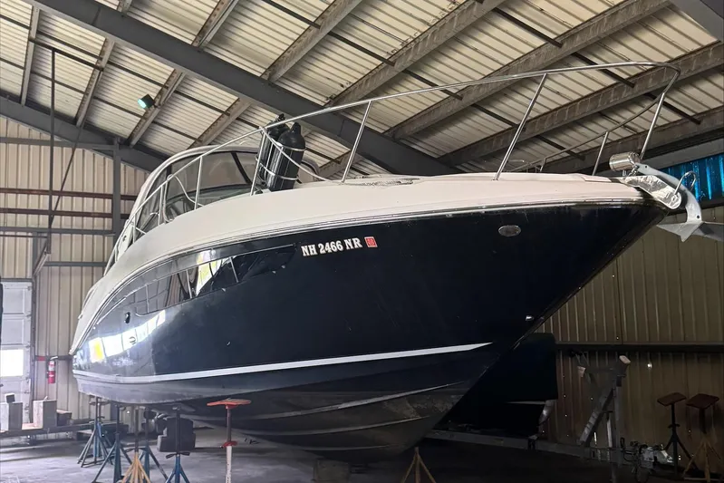  Yacht Photos Pics 2013 Sea Ray 370 Sundancer yacht in storage, viewed from the front in a warehouse.
