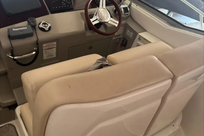  Yacht Photos Pics 2013 Sea Ray 370 Sundancer helm with beige seating and modern controls.