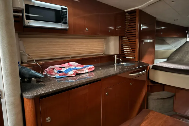  Yacht Photos Pics Interior of 2013 Sea Ray 370 Sundancer yacht with kitchenette and bed.
