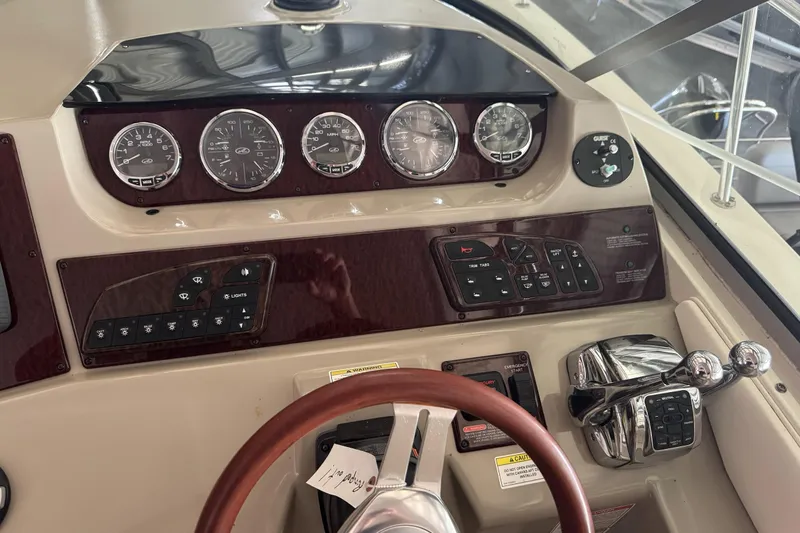  Yacht Photos Pics Control panel of a 2013 Sea Ray 370 Sundancer boat with gauges and steering wheel.