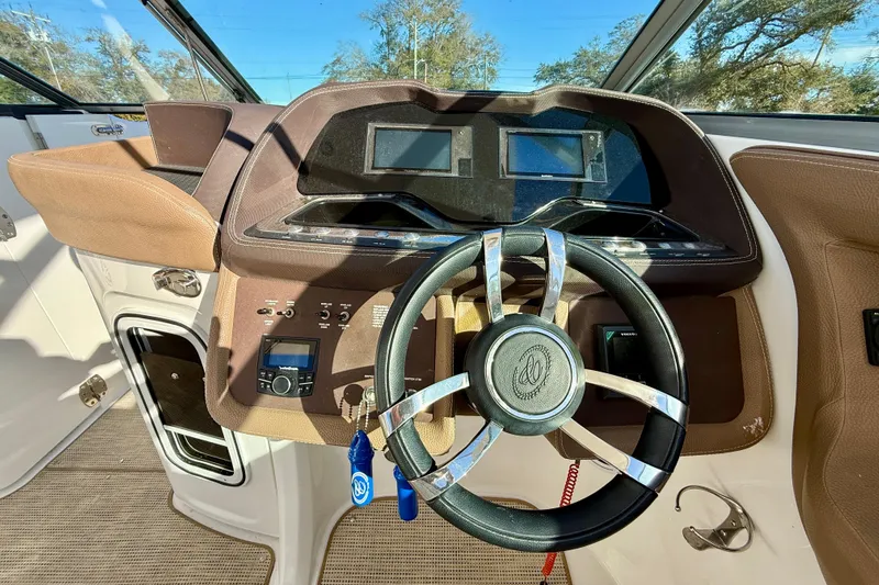  Yacht Photos Pics Steering wheel and dashboard of 2018 Cobalt R35 boat, featuring modern controls and displays.