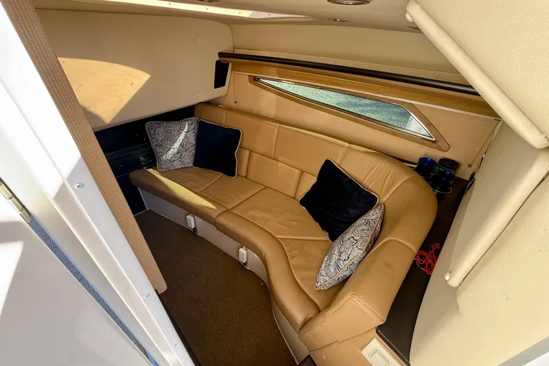  Yacht Photos Pics Luxurious interior of 2018 Cobalt R35 boat with tan leather seating and decorative pillows.