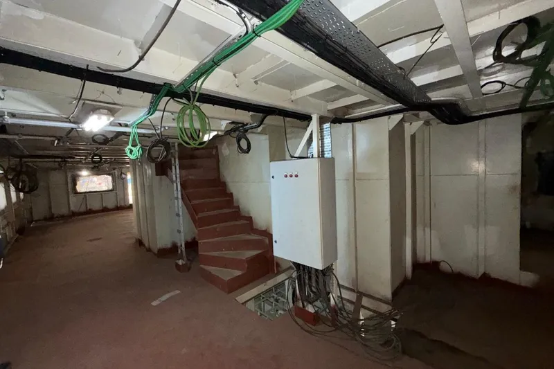 Nirvana Yacht Photos Pics Interior of a 2027 Soyaslan Custom ship, featuring exposed wiring and metal stairs.