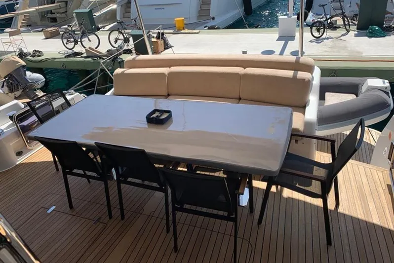  Yacht Photos Pics Outdoor dining area on a 2021 Sirena 64 yacht with table and chairs.