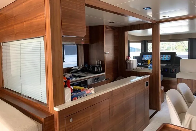  Yacht Photos Pics Luxurious interior of 2021 Sirena 64 yacht featuring modern kitchen and navigation area.