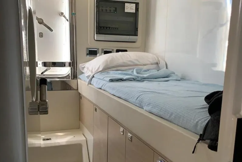  Yacht Photos Pics Compact cabin interior of 2021 Sirena 64 yacht with bed and storage.