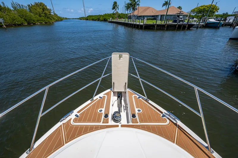  Yacht Photos Pics Bow view of 2006 Regal Commodore 3560 IO yacht on a serene waterway.