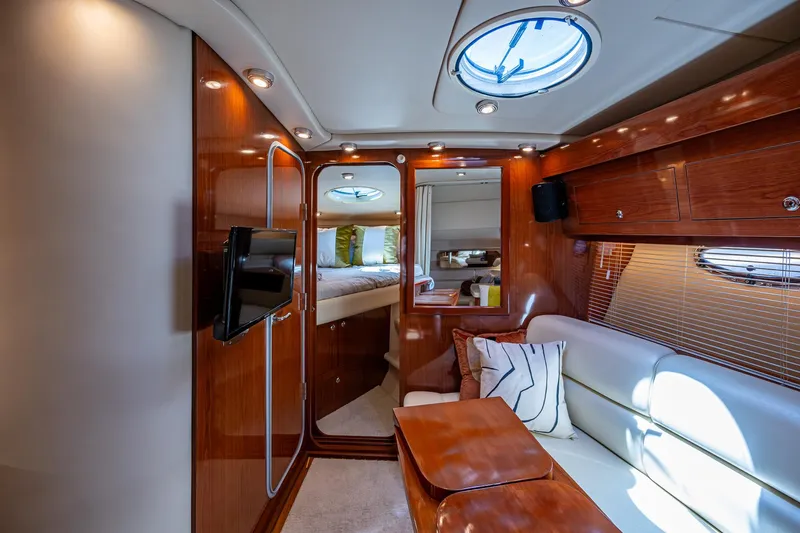  Yacht Photos Pics Luxurious interior of 2006 Regal Commodore 3560 IO yacht with wood finish and plush seating.