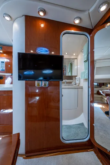 Yacht Photos Pics 2006 Regal Commodore 3560 IO yacht interior with TV, wood paneling, and modern amenities.