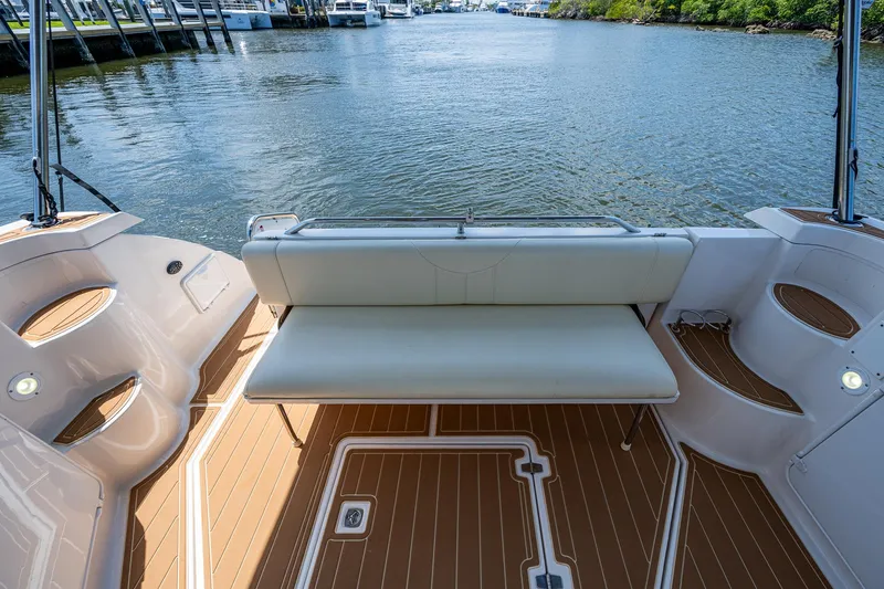  Yacht Photos Pics 2006 Regal Commodore 3560 IO boat with spacious seating, docked by a serene waterway.