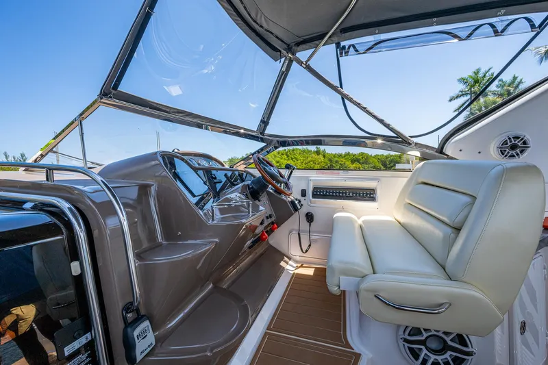  Yacht Photos Pics 2006 Regal Commodore 3560 IO boat interior with steering wheel and seating.
