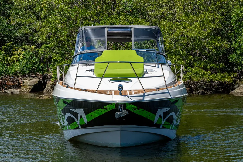  Yacht Photos Pics 2006 Regal Commodore 3560 IO boat on water, front view, with green accents.