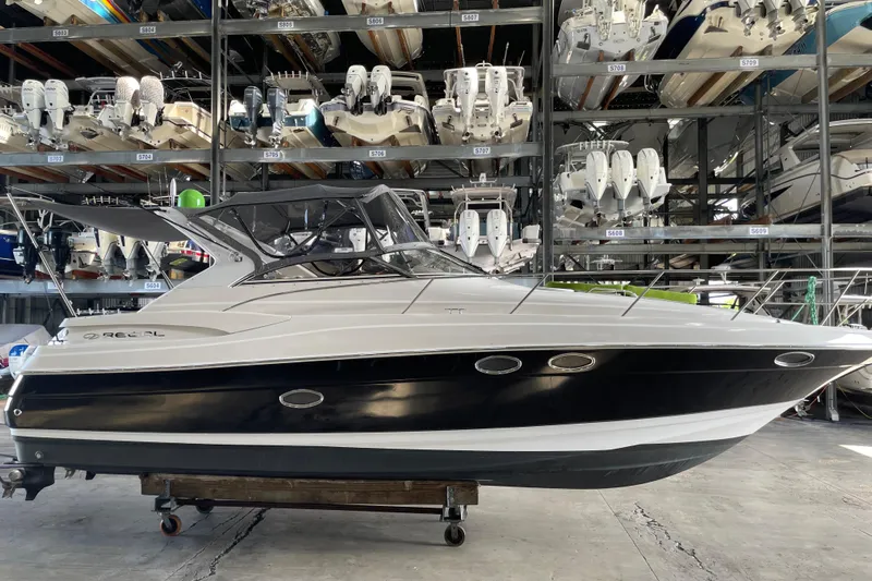  Yacht Photos Pics 2006 Regal Commodore 3560 IO boat in storage, surrounded by other vessels.