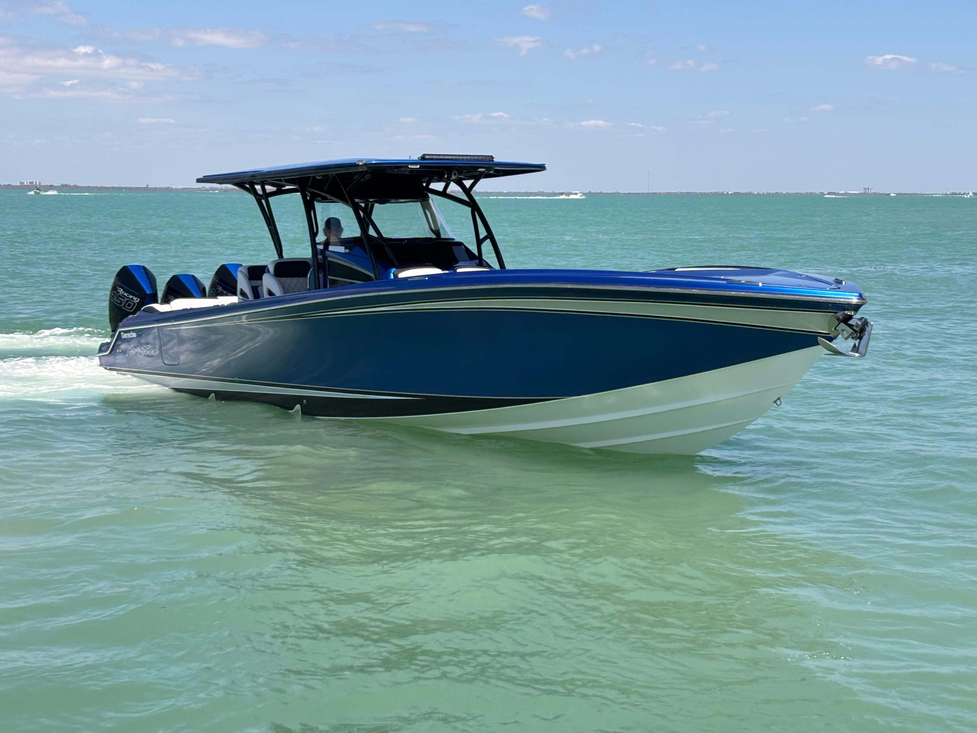 2020 Nor-Tech 390 Sport boat cruising on clear blue water.
