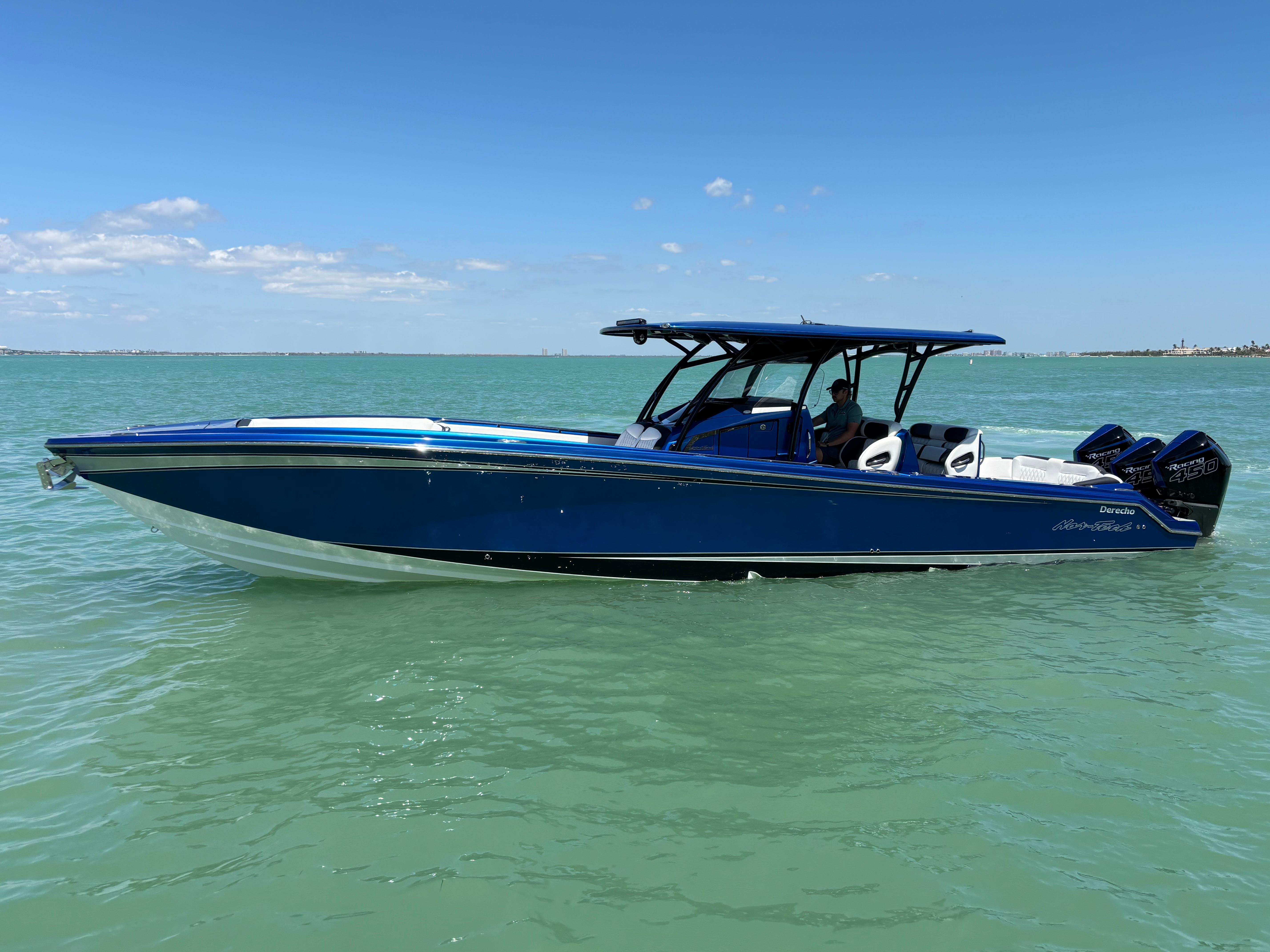 2020 Nor-Tech 390 Sport boat on calm turquoise water under a clear blue sky.