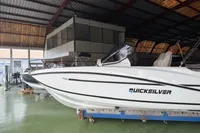 2025 Quicksilver 705 Open boat in a showroom, side view.