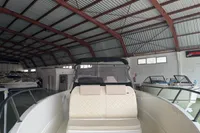 2025 Quicksilver 705 Open boat in a spacious indoor showroom.