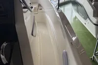 2025 Quicksilver 705 Open boat interior in showroom, showcasing sleek design and spacious layout.