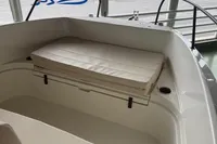 2025 Quicksilver 705 Open boat interior with cushioned seating and railing.