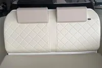 2025 Quicksilver 705 Open boat interior with quilted white seating.