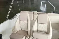 Interior of 2025 Quicksilver 705 Open boat with two beige seats in a showroom.