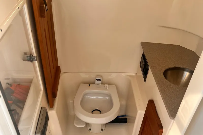  Yacht Photos Pics 2001 Pursuit 3070 Offshore Center Console boat bathroom with sink and toilet.