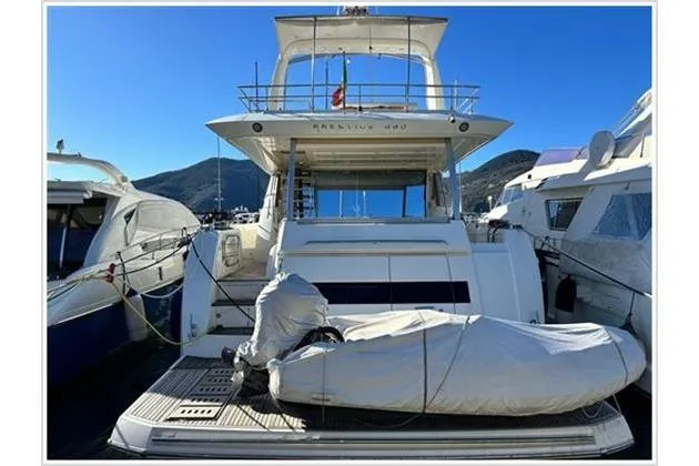  Yacht Photos Pics Luxury 2016 Prestige 680 Fly yacht docked, featuring covered equipment on deck.