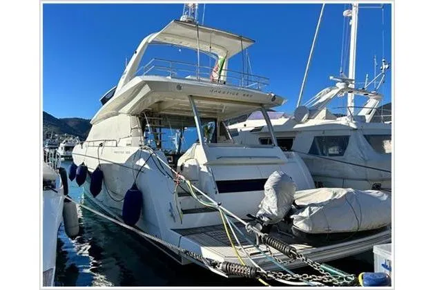  Yacht Photos Pics 2016 Prestige 680 Fly yacht docked in marina, featuring spacious flybridge and sleek design.