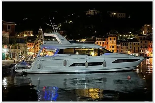  Yacht Photos Pics Luxury Prestige 680 Fly yacht docked at night, 2016 model, illuminated waterfront.