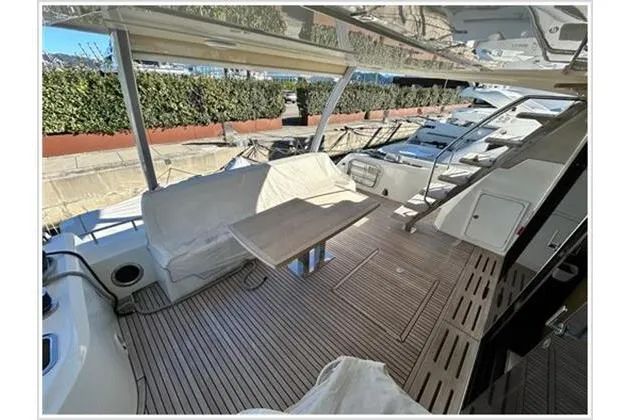  Yacht Photos Pics Prestige 680 Fly 2016 yacht deck with seating and table, showcasing luxury and comfort.