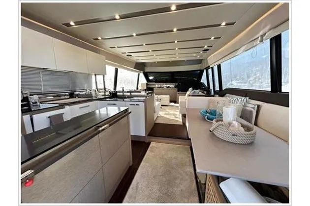  Yacht Photos Pics Luxurious interior of 2016 Prestige 680 Fly yacht with modern kitchen and seating area.