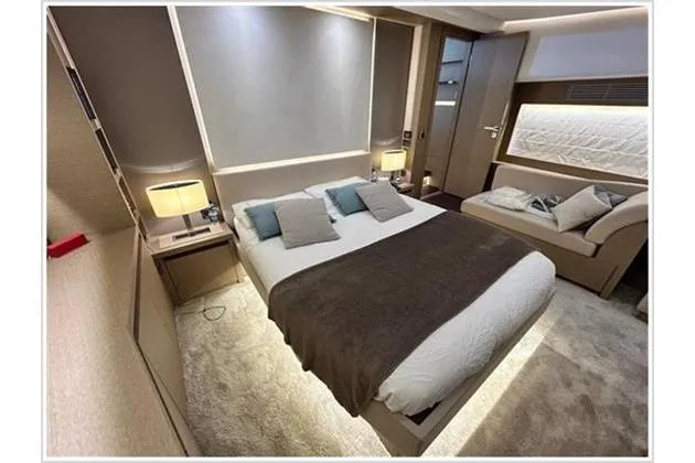  Yacht Photos Pics Luxurious bedroom interior of 2016 Prestige 680 Fly yacht with modern decor and ambient lighting.