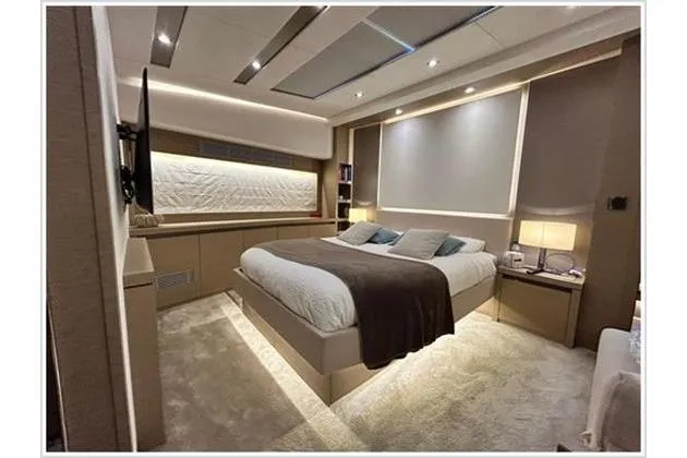  Yacht Photos Pics Luxurious bedroom interior of 2016 Prestige 680 Fly yacht, featuring modern design and ambient lighting.