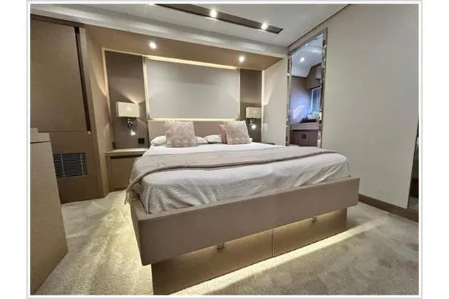  Yacht Photos Pics Luxurious bedroom interior of 2016 Prestige 680 Fly yacht, featuring elegant design and ambient lighting.