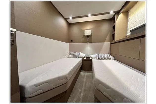  Yacht Photos Pics Twin cabin interior of 2016 Prestige 680 Fly yacht, featuring modern design and cozy beds.