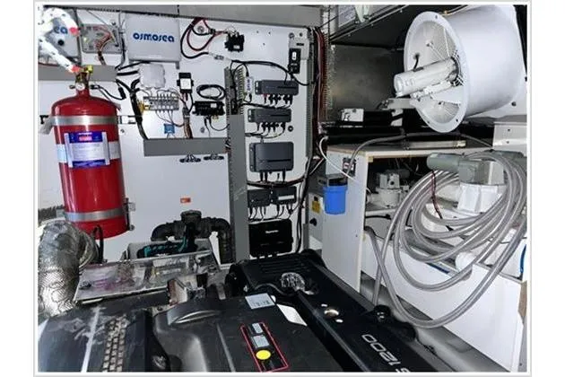  Yacht Photos Pics Engine room of a 2016 Prestige 680 Fly yacht, featuring equipment and fire extinguisher.