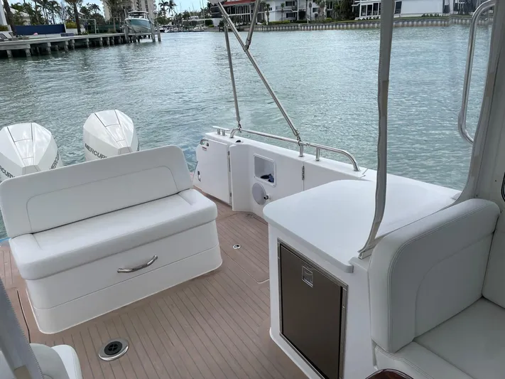  Yacht Photos Pics 2023 MJM 35z boat interior with white seating and scenic waterfront view.