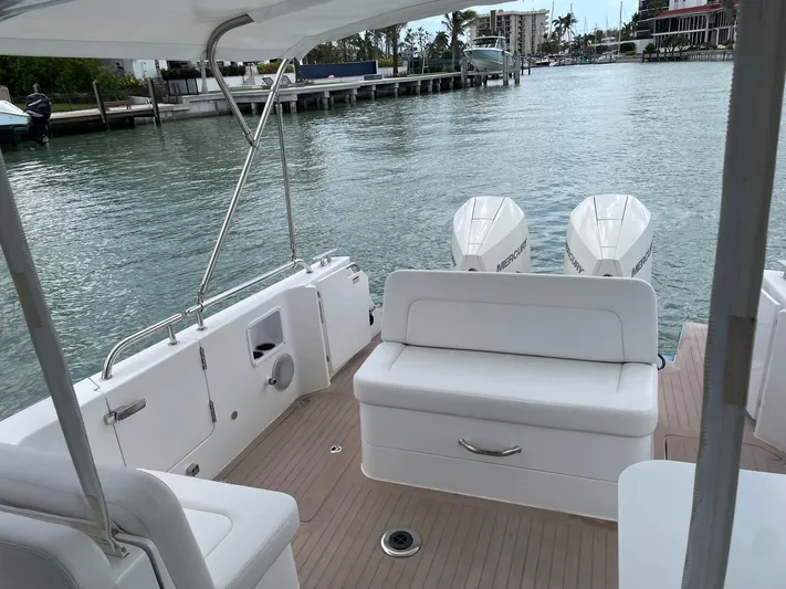  Yacht Photos Pics 2023 MJM 35z boat with twin engines, docked on a calm waterfront.
